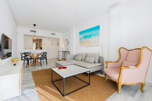 A modern living room with a sofa, a coffee table, and a decorative chair.