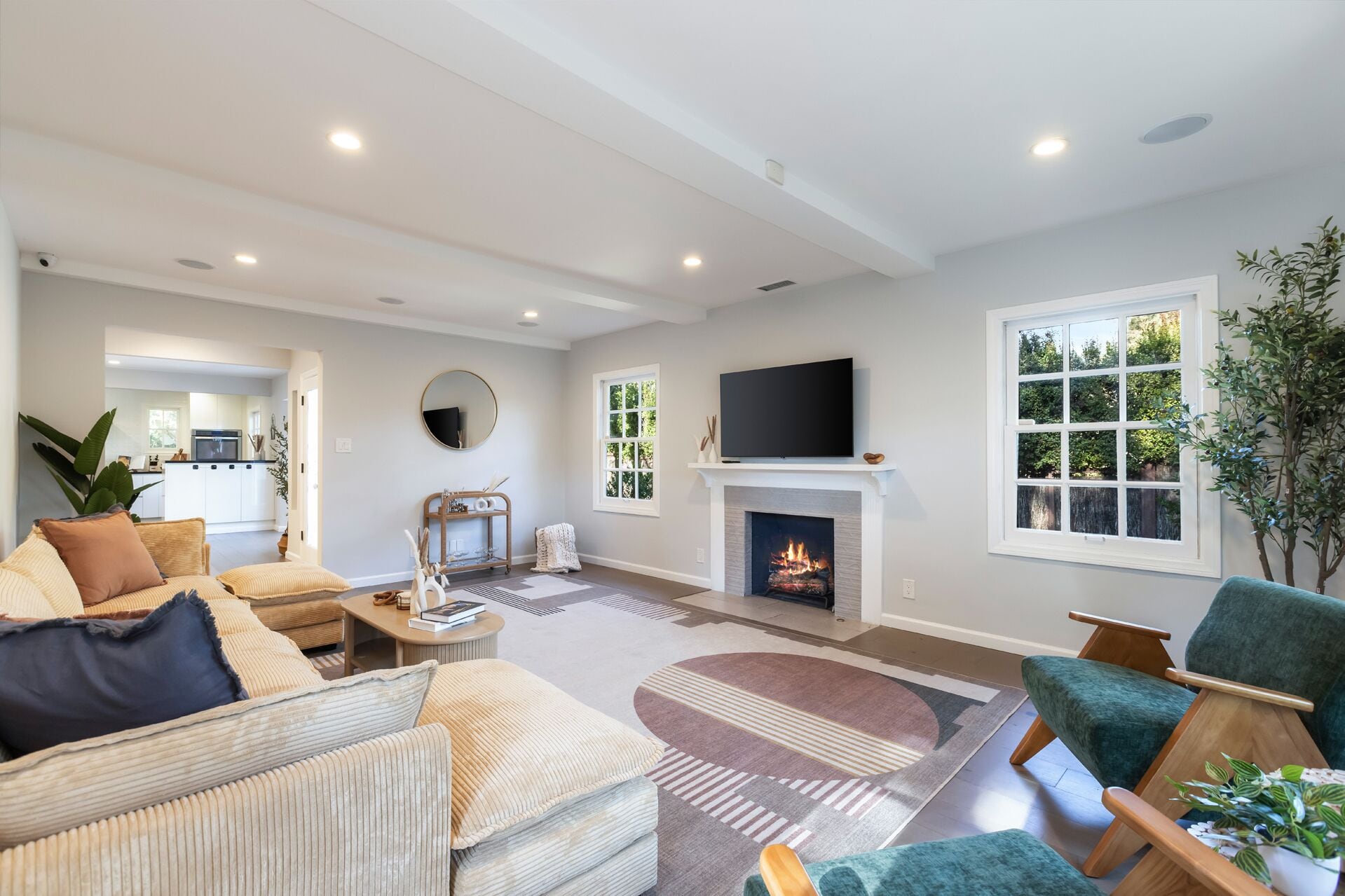 A modern living room with a fireplace, a television, and comfortable seating.