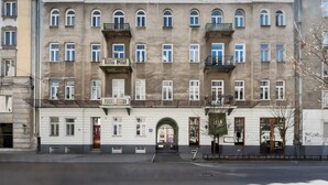 A multi-story building with a symmetrical facade, large windows, and balconies.