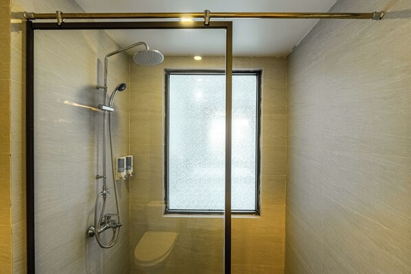 A modern bathroom with a glass shower enclosure, a toilet, and a window. - An Khang Hotel (Ha Giang 1)