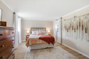 A bedroom with a bed, dresser, bedside lamps, and a macrame wall hanging. - Sale- Golf Course Getaway-Message for Discount on 2 courses on property (Lima)