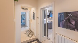 A hallway with a 'Private Property No Trespassing' sign, a patterned floor, and a door leading to a bathroom. - Casa Mabel - Lecce Selection (Lecce)