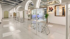 A spacious, modern lobby with a high ceiling, glass panels, and a reception desk. - Shanghai MOCOKI hotel (Shanghai)