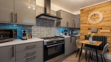 Luxury Suite | Private kitchen | Full-size fridge, microwave, stovetop, electric kettle