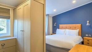 A bedroom with a bed, bedside tables, a wardrobe, and a window. - Jura Premier Lodge with Hot Tub (Ayr)