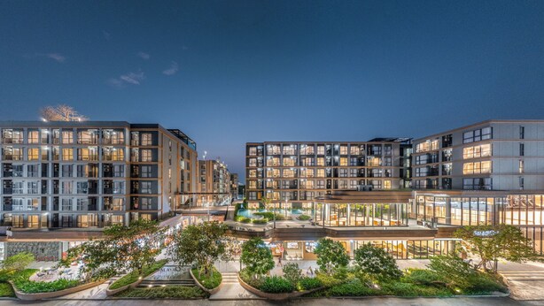 A modern multi-story hotel with a central courtyard, outdoor seating, and a pool area. - Salaya One Hotel & Service Apartment (Phutthamonthon)
