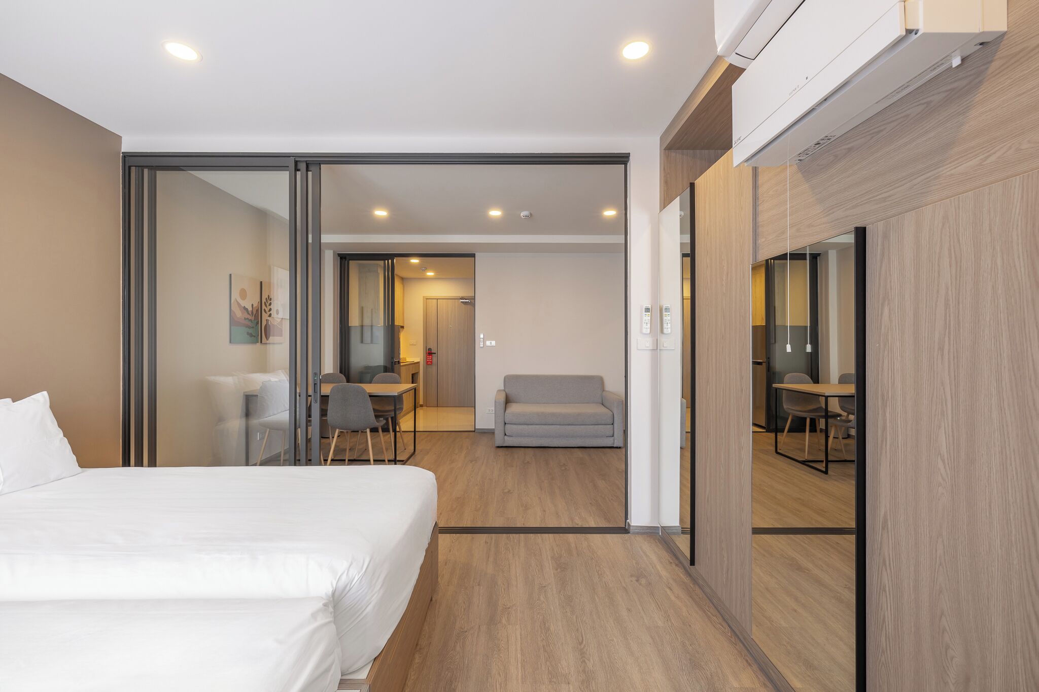 Una habitación de hotel moderna con una cama grande, un escritorio y una zona de estar.