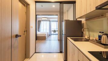 A modern kitchen with a refrigerator, sink, and countertop.