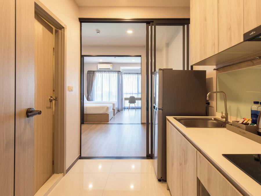A modern kitchen with a refrigerator, sink, and countertop.