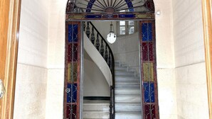 A grand staircase with ornate metal railings and a decorative fanlight above. - EL BALCÓN MÁLAGA MALAGA (MALAGA)