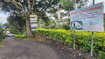 A signboard advertising a fibre-reinforced polymer dome with features like eco-friendliness, fireproofing, and a 210 sq ft farm room.
