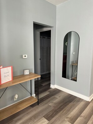 A hallway with a wooden bench, a 'Guest Book,' and a 'Happy Home' sign.