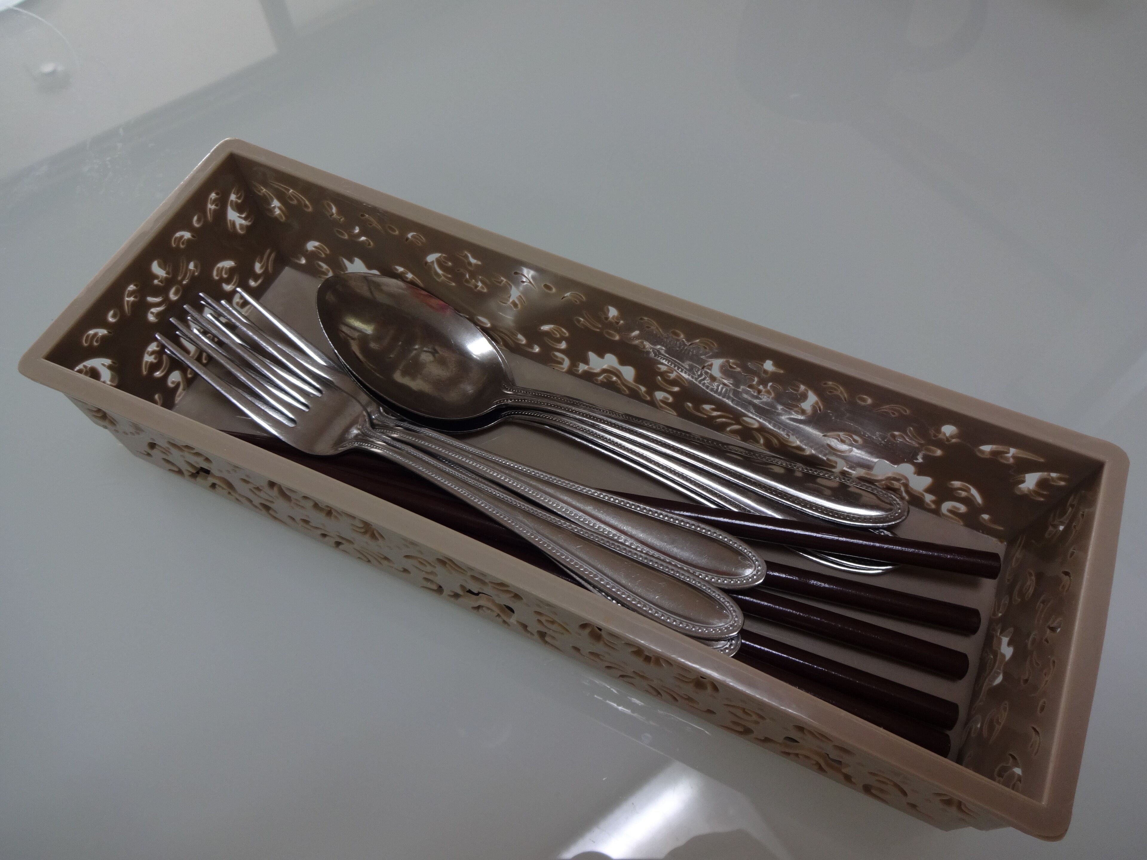 A tray with a spoon, fork, and knife.