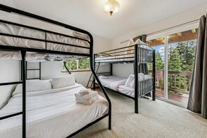 A bunk bed room with a view of the outdoors.