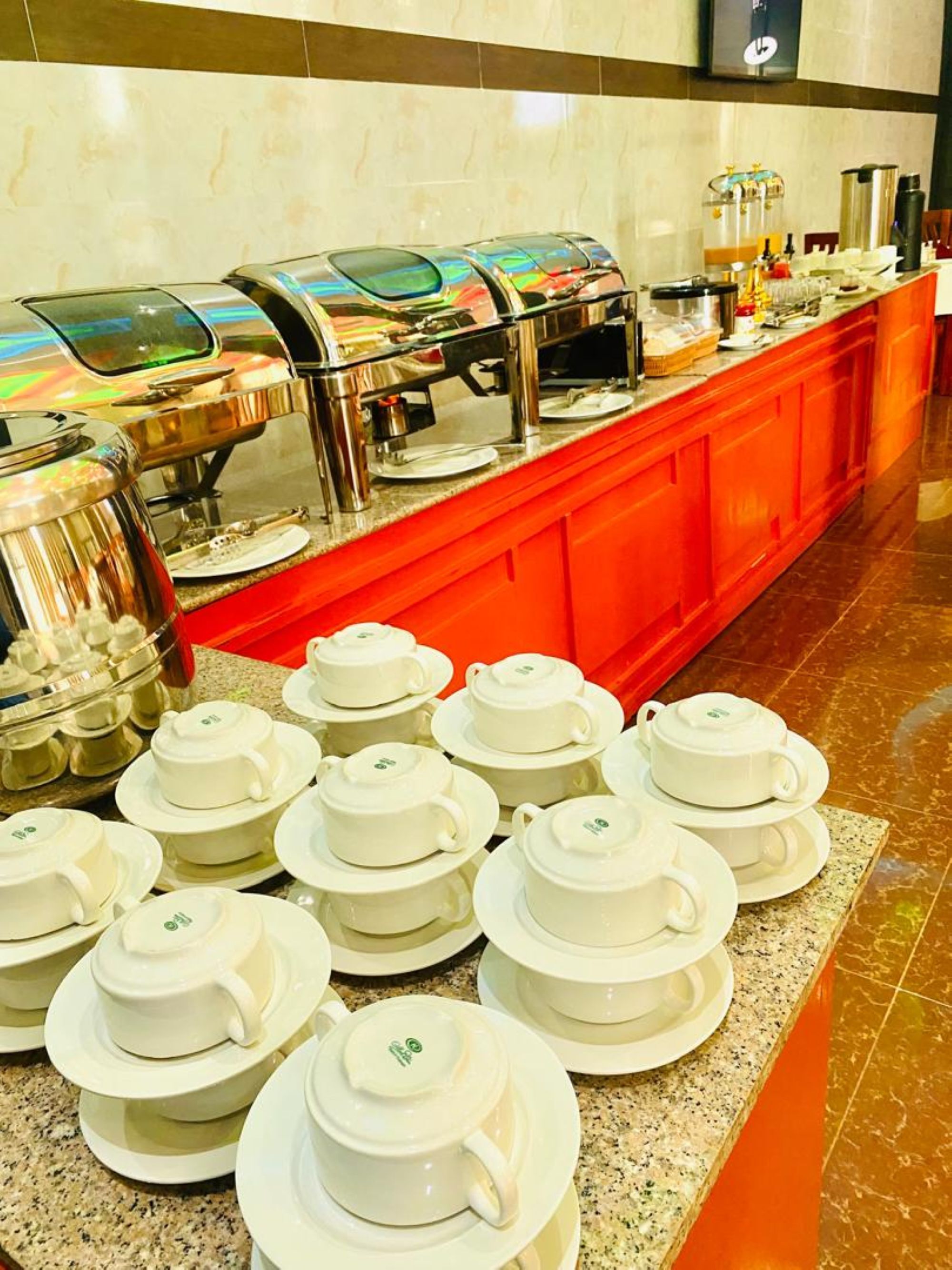 A buffet area with multiple self-service stations and a variety of food items.