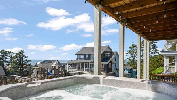 A hot tub area with a view of a residential neighborhood and a house in the background.