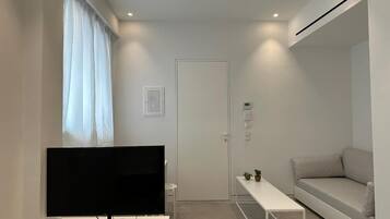 Apartment, City View | Living area | Flat-screen TV
