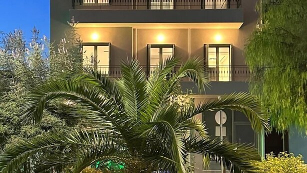 A multi-story building with balconies and windows, surrounded by greenery. - Suite No1 (Rethymno)