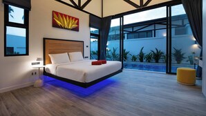 A modern bedroom with a hanging bed, large windows, and a view of a swimming pool. - New 17m Eco Pool Villa Sunset Garden 12 (Rawai)