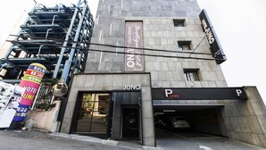 A hotel with a modern design, a visible entrance, and a parking area. - HOTEL JUNO (Incheon)