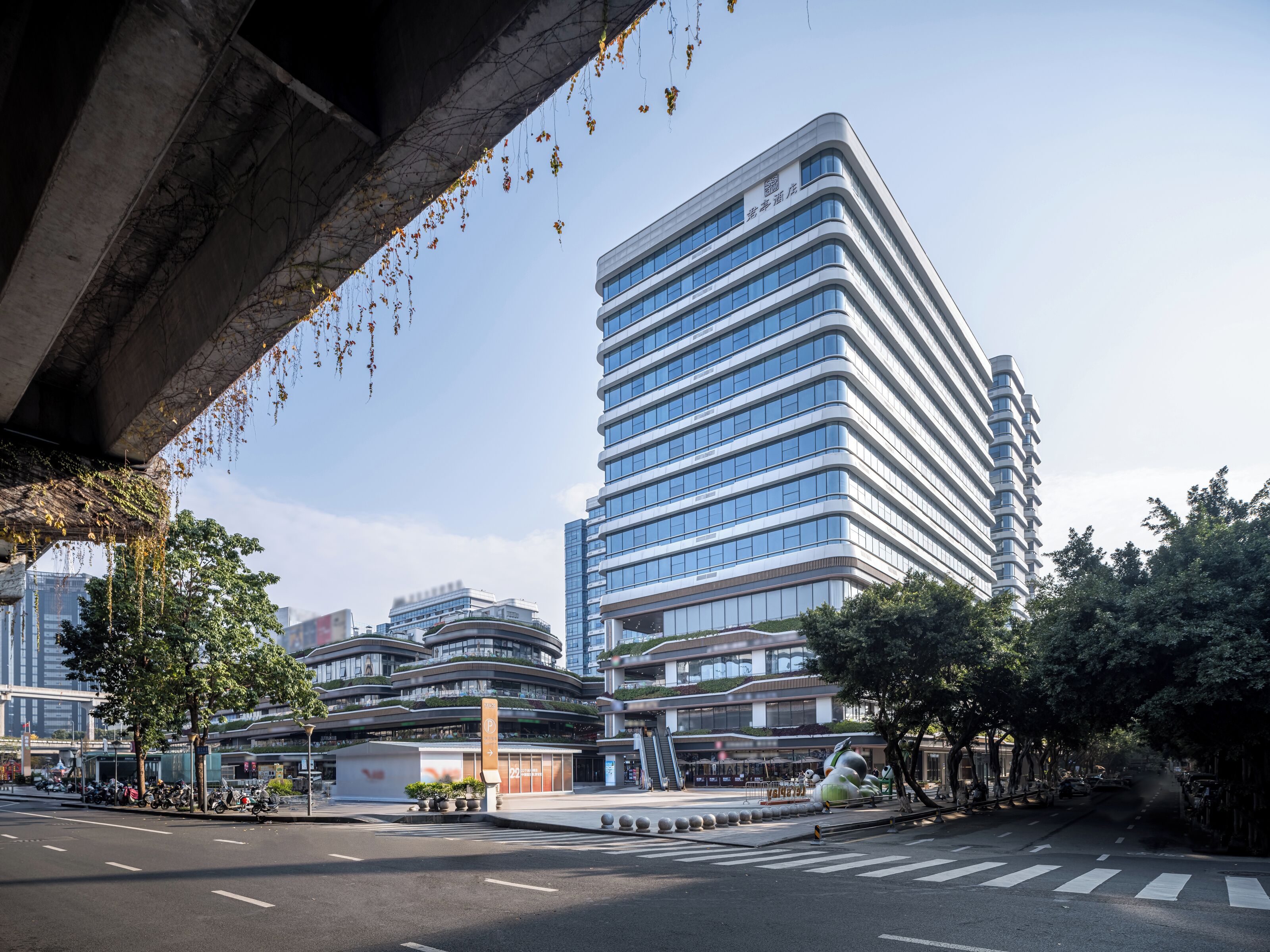 A modern building with a curved facade and multiple windows.