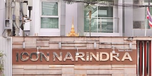 A building with a sign reading "ICON NARINDRA" and a golden structure above it. - Icon Narindra Suites Hotel (Bangkok)