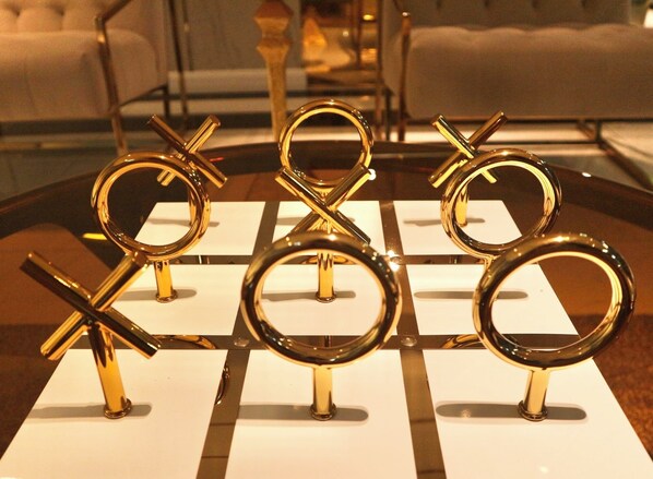 A table with a geometric pattern and golden circular objects on top. - Icon Narindra Suites Hotel (Bangkok)