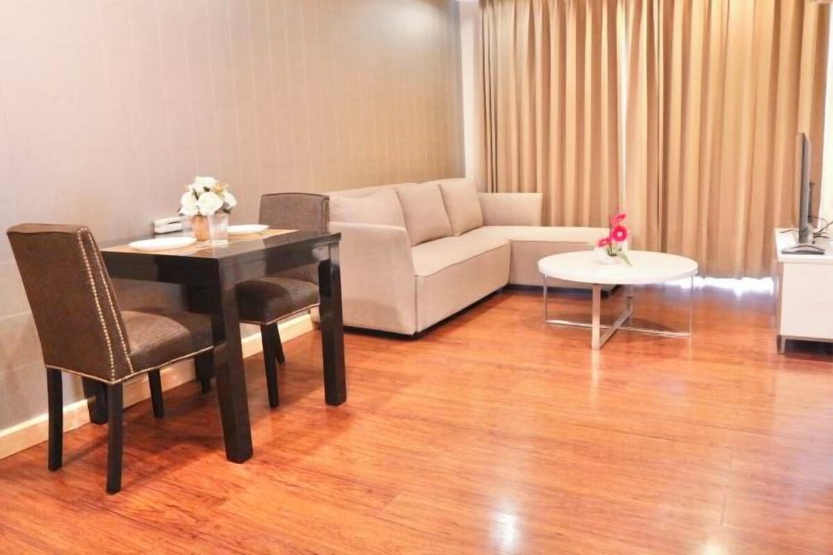 A modern living room with a dining table, sofa, and coffee table.