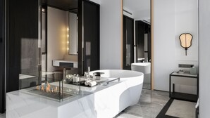 A modern bathroom with a large freestanding bathtub, a glass-enclosed shower area, and a vanity with a sink. - FU VALLEY (Changzhou)