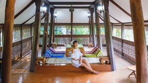 A wooden pavilion with a high ceiling and a chandelier. It features a central seating area with colorful cushions and a patterned rug. - Ban MaeBo Local Stay (Mae Rim)