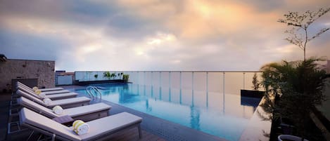 Outdoor pool, open 7:00 AM to 7:00 PM, pool umbrellas, sun loungers