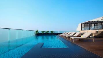 Outdoor pool, open 7:00 AM to 7:00 PM, pool umbrellas, pool loungers