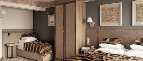 A hotel room with a bed, a nightstand, a lamp, and a wardrobe.