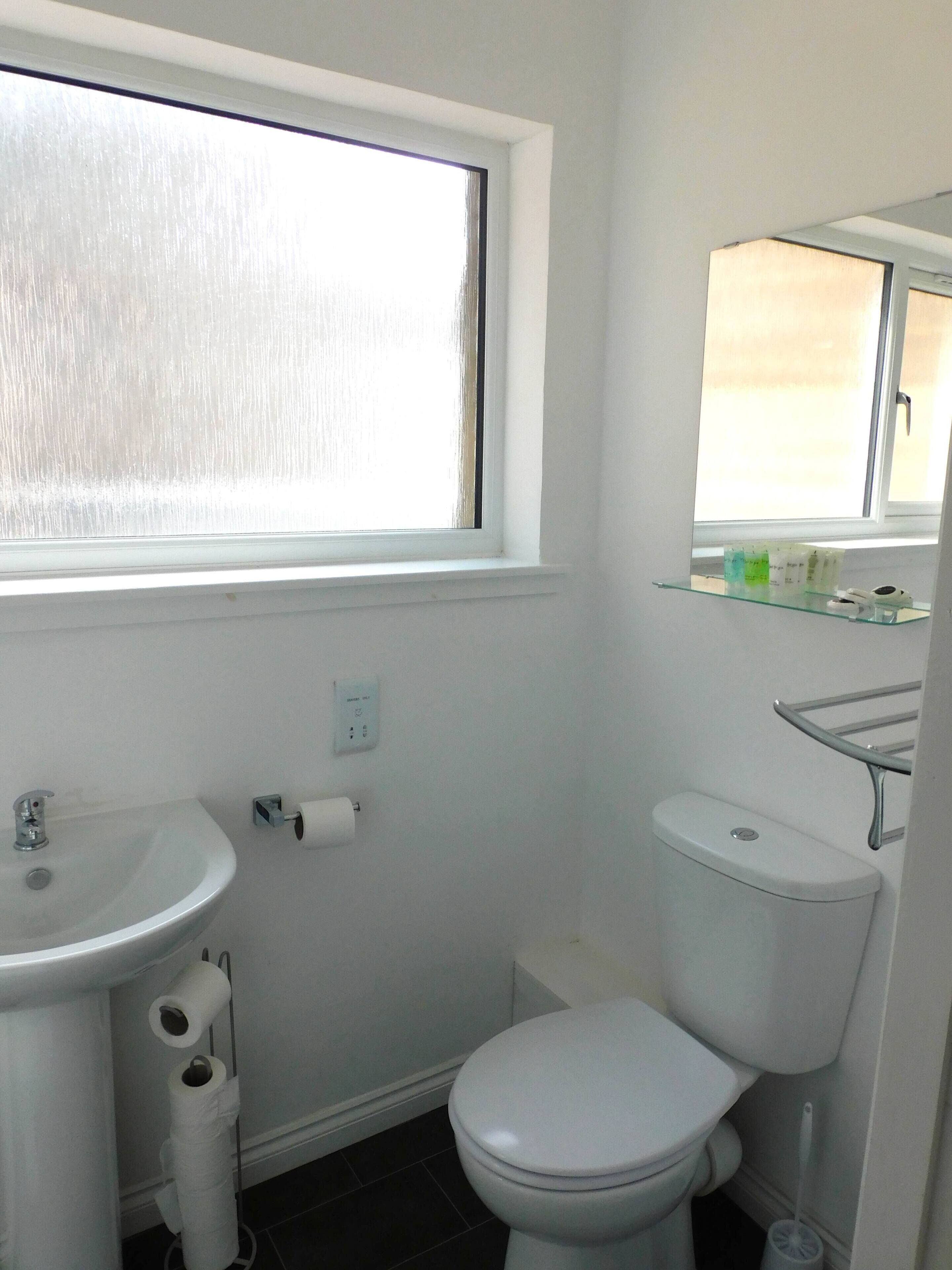 Shower, hair dryer, towels, shampoo