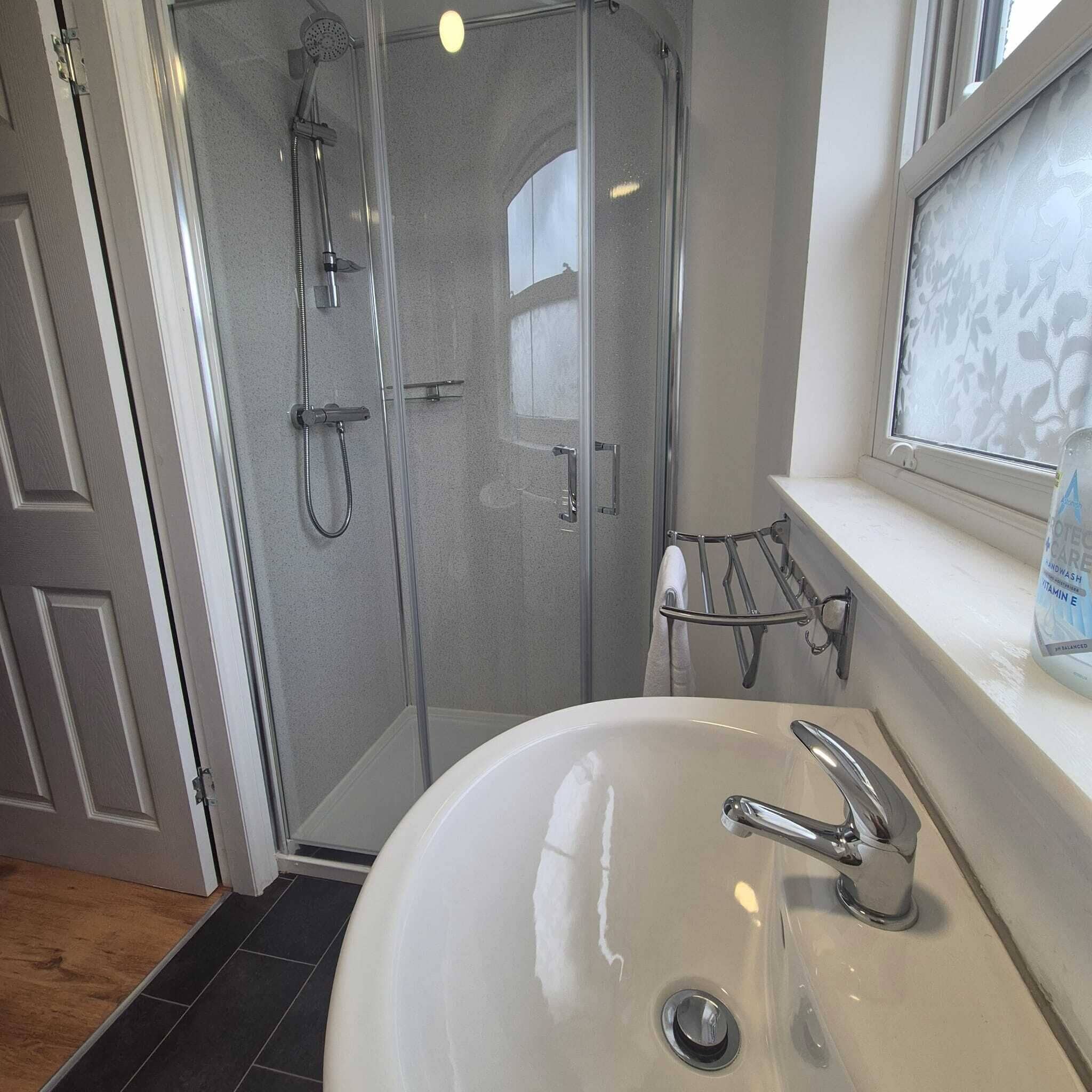 Shower, hair dryer, towels, shampoo