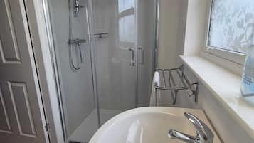 Shower, hair dryer, towels, shampoo