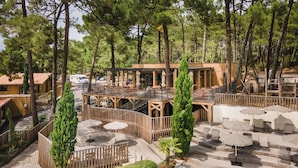 Ein Resort mit Pool, Sitzgelegenheiten im Freien und einer Holzterrasse.