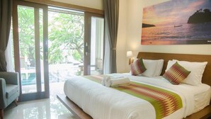 A hotel room with a large bed, a view of the outdoors, and a painting of a sunset over water. - Akatara Hotel (Penida Island)