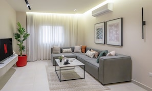 Deluxe Apartment, 2 Bedrooms | Living area | 50-inch Smart TV with satellite channels