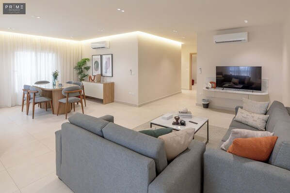 Apartment, 3 Bedrooms | Living area | 50-inch Smart TV with satellite channels