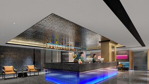 A modern bar area with a unique textured ceiling, a bar counter with a blue-lit base, and seating with yellow chairs. - Lan Wan International Hotel  (Guangzhou)