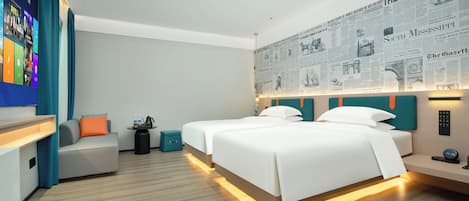 A modern hotel room with two beds, a flat-screen TV, and a wall with newspaper clippings.