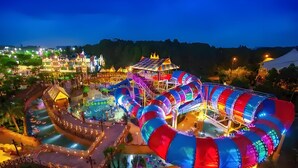 A brightly lit amusement park at night with various rides and attractions. - Lan Wan International Hotel  (Guangzhou)