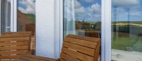 A wooden bench and table outside a building with a sign reading "THE LOOKOUT".