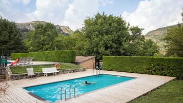 Seasonal outdoor pool, open 9:00 AM to 6:00 PM, pool umbrellas
