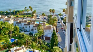 A coastal resort with multiple-story buildings, a swimming pool, and palm trees. - Marbella - Beachside One bedroom apartment (Marbella)