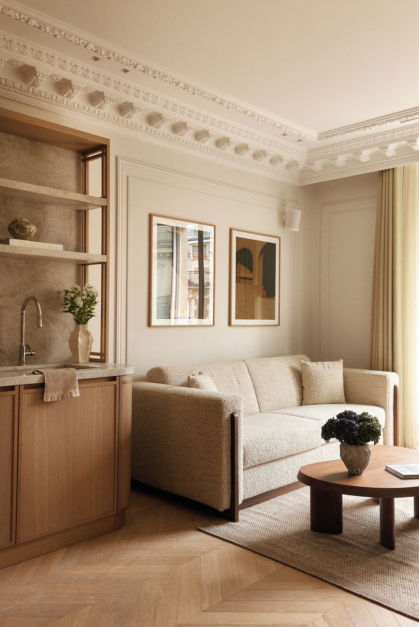 A living room with a sofa, coffee table, and a decorative shelf.