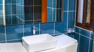 Separate bathtub and shower, slippers, towels, soap