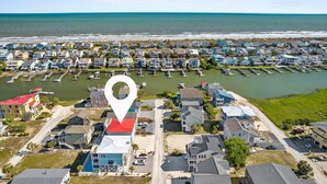 An aerial view of a coastal residential area with houses, a marina, and a beach. - Escape to Sunset Serenity, a spacious 4BR 3BA retreat in beautiful Sunset Beach, NC. (Sunset Beach)
