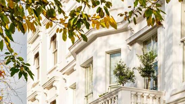 A classical building with a symmetrical facade, large windows, and a central entrance with columns. - Kensington High Life- by Out of Office Lifestyle (London)